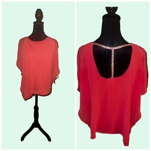 Women’s size small flowing shirt with cut out back and rhinestones